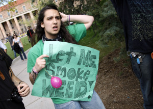 A woman holds a sign at a pro-marijuana rally at the University of Colorado in Boulder